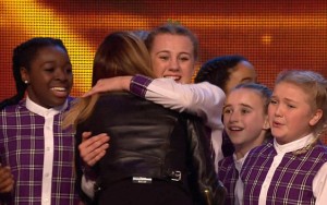 An emotional Dolcie as Britain's Got Talent judge Alesha Dixon hugs a fellow group member after giving them a golden buzzer on last Saturday's show.